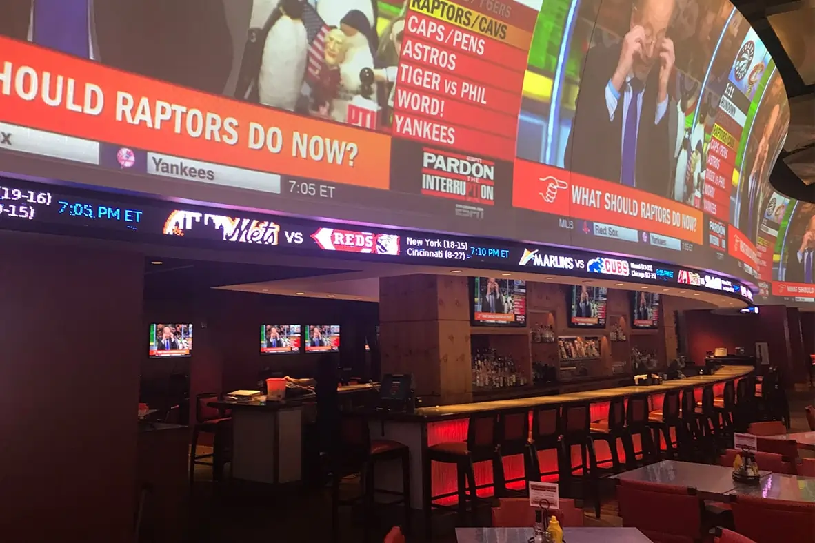 Serpentine shaped ticker inside High Velocity Sports Bar by Rise Display.