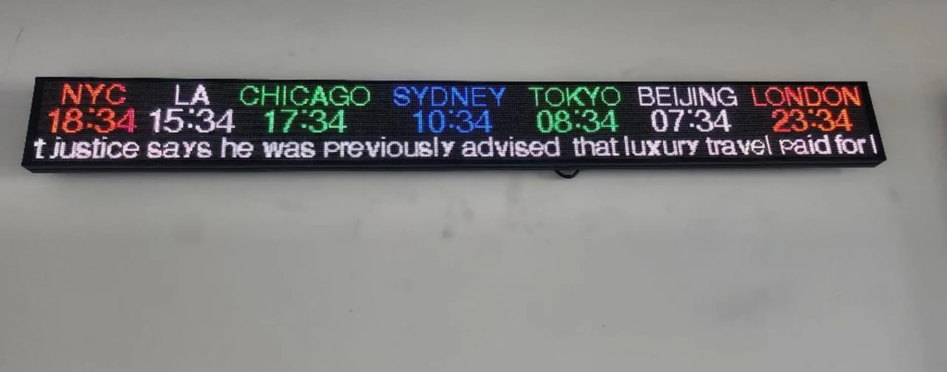 A Rise Display stock ticker mounted to a wall, displaying several rows of financial information.
